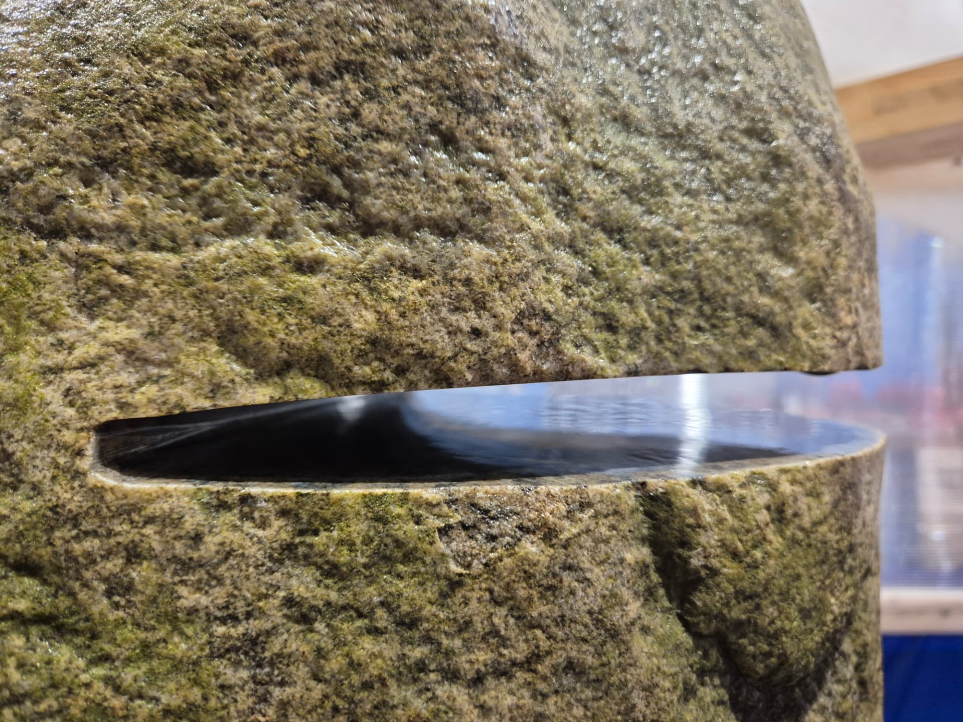 A narrow slot cut through a boulder in testing